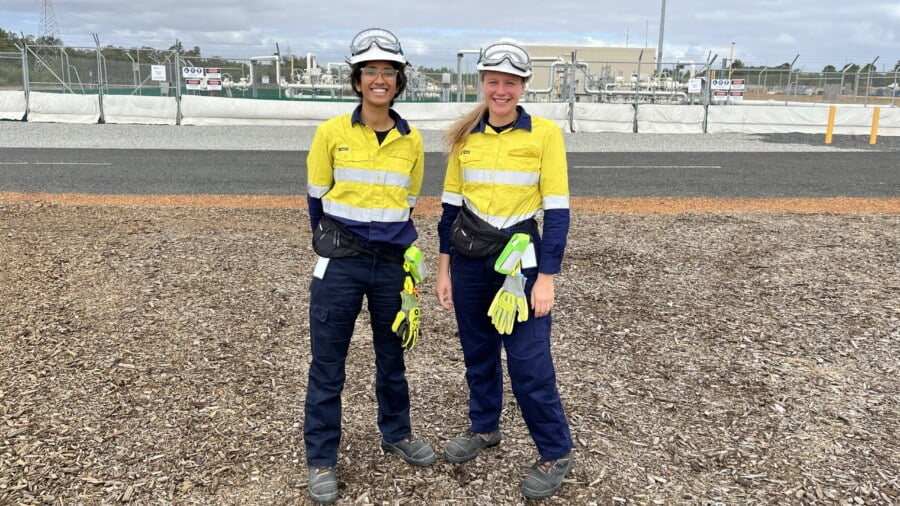 Two women standing in PPE